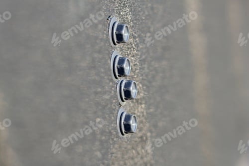 Preview: Set of metallic bolts fastened on iron sheet outdoors. Building, construction and repairing, copy