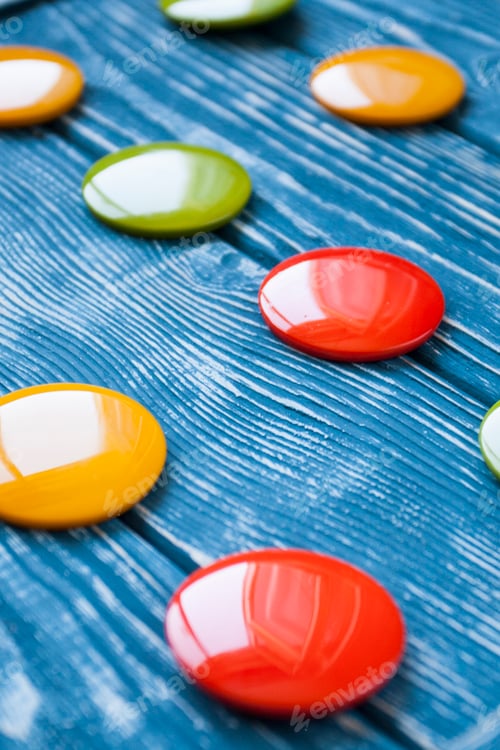 Preview: A set of colorful glass buttons for clothes on a dark wooden background