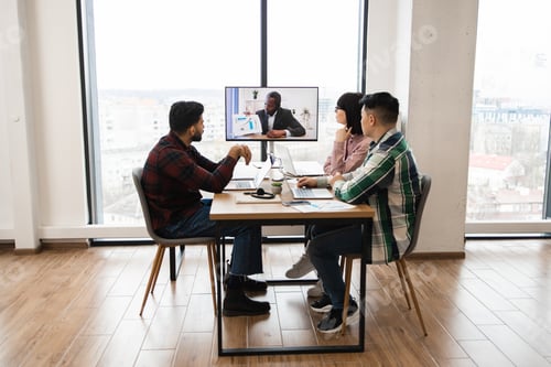 Preview: Group of coworkers in video conference meeting at modern office