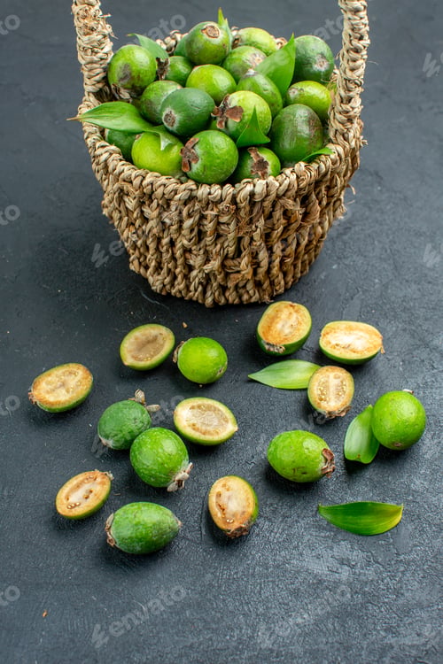 Preview: front view fresh feijoas in basket on dark background