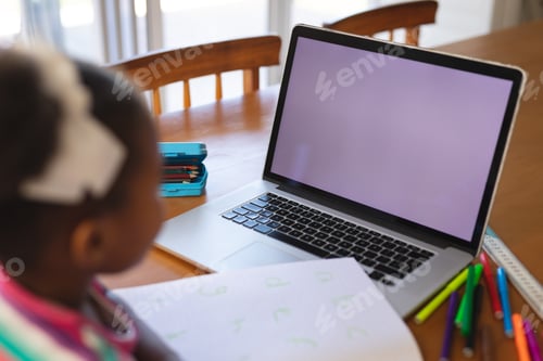 Preview: Child Learning with Laptop and School Supplies