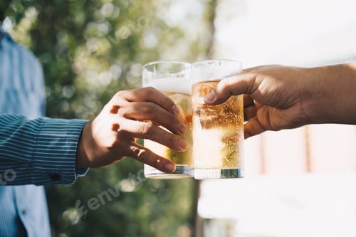 Preview: Multiracial group of friends enjoying a beer, Young people hands toasting and cheering aperitif beer