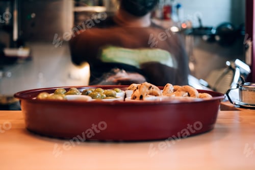 Preview: waiter preparing a tray with appetizers in the restaurant