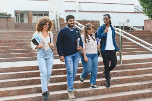 Preview: Diverse students walking down university campus stairs