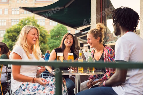 Preview: Friends having beer in sidewalk cafe