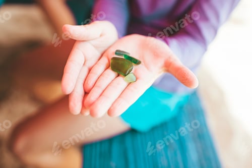 Preview: Girl holding up sea glass