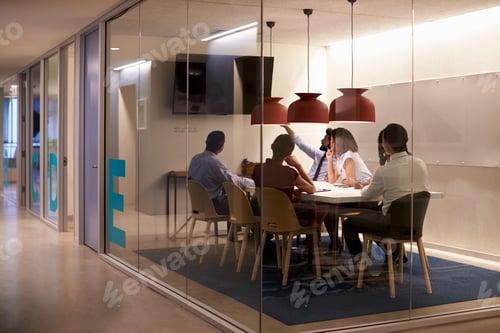 Preview: Corporate business team using AV display in meeting cubicle