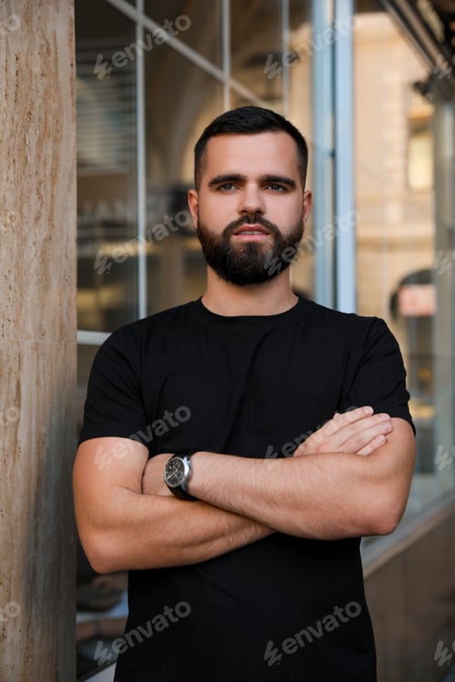 Preview: Portrait of handsome bearded man near building outdoors