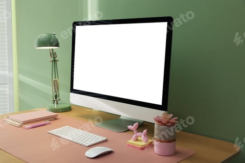 Preview: Stylish workplace with computer and pink mat on desk in office, closeup