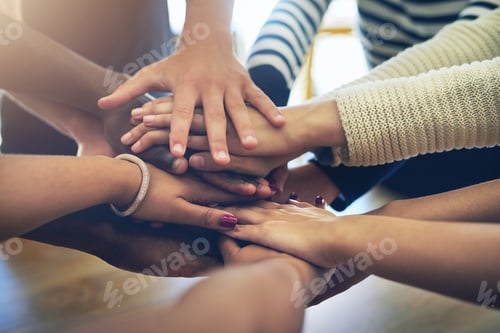 Preview: Shot of a group of unidentifiable friends joining their hands in solidarity