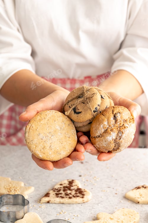Preview: Homemade cookies in female hands, Christmas baking concept.