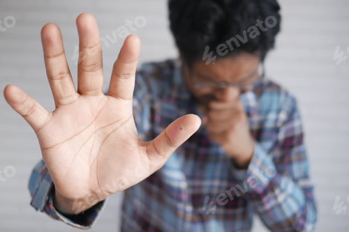 Preview: young sick man coughing and sneezes