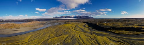 Preview: Landscape of the Markarfljot river in a field covered in greenery in Iceland