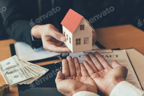 Preview: Home agents are giving house gifts to new home buyers in office room.