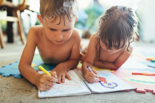 Preview: Little boy and girl drawing with crayons