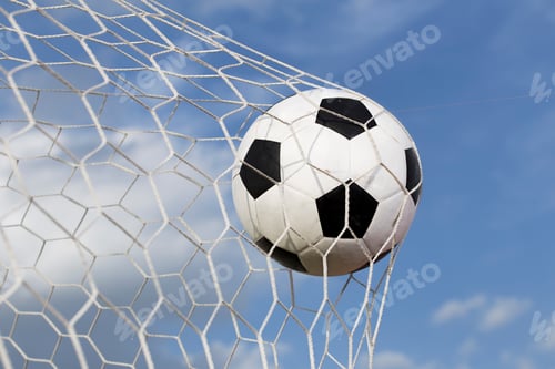 Preview: soccer ball in the net on blue sky background