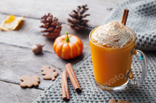 Preview: Pumpkin Latte with Spices. Boozy Cocktail with Whipped Cream. Wooden Background.