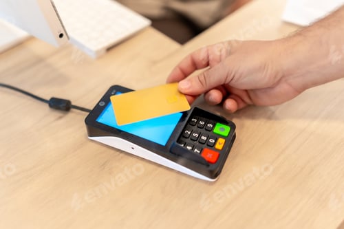 Preview: Hand of a man paying with credit card in store