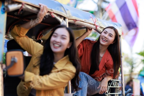 Preview: Happy asian women enjoying rickshaw ride during vacation