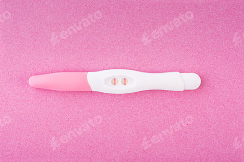 Preview: Positive pregnancy test isolated on pink background