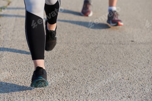Preview: Close-Up: Athletic Runner's Legs Captured in Action on a Sunny Day.