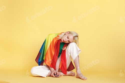 Preview: Studio photo of a fashionable man with make up isolated on yellow background