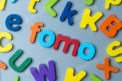 Preview: Colorful wooden alphabet letters arranged to form the word FOMO.