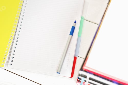 Preview: open blank notepad with pen and stack of books. white table, working space, learning