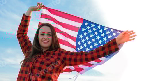Preview: Young millennial brunette woman holding The National Flag of USA. American Flag. Tourist traveler or