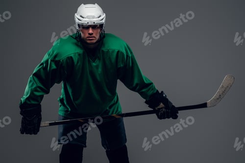Preview: Portrait of hockey player isolated on grey background.