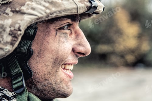 Preview: Portrait of smiling army soldier in ragged helmet