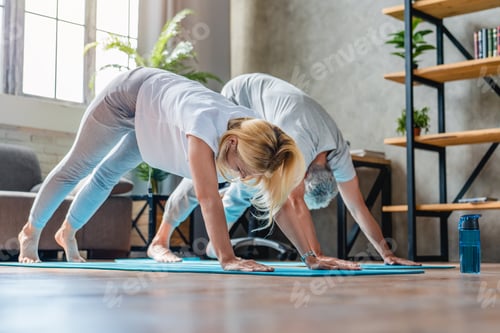 Preview: Two middle aged people doing yoga exercise at home