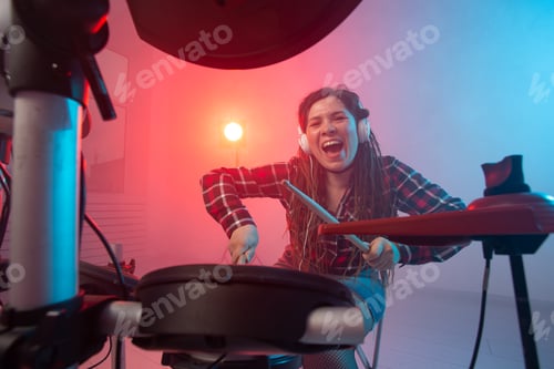 Preview: Hobby, music and people concept - Excited woman playing the electronic drum set