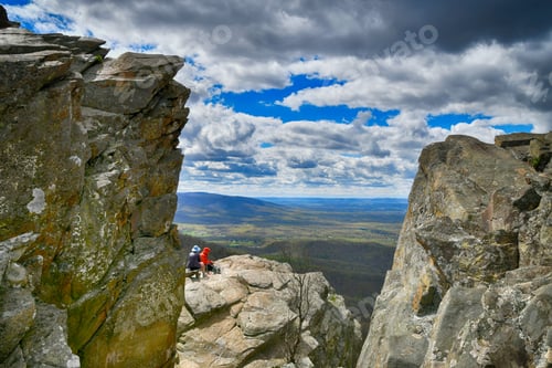 Preview: A couple having picnic on rock ledge overlooking Shenandoah Valley of Virginia. Blue Ridge Mountains