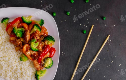 Preview: Chicken teriyaki and broccoli on dark background with balsamic sauce and sesame seeds stir fry with