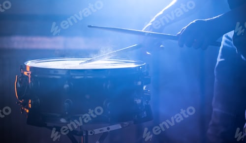 Preview: man playing the snare drum on a beautiful colored background