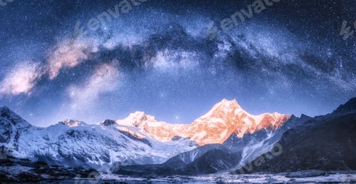 Preview: Milky Way arch over snowy mountains at starry night in winter.