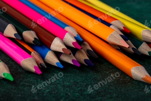 Preview: side view of a set of colored pencils on dark background