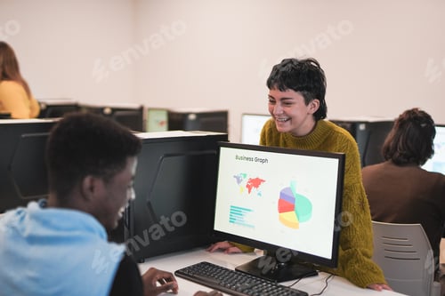Preview: Multiracial students talking together during computer business class at university