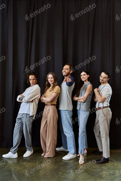 Preview: african american team lead pointing at camera near multiethnic colleagues with folded arms on black
