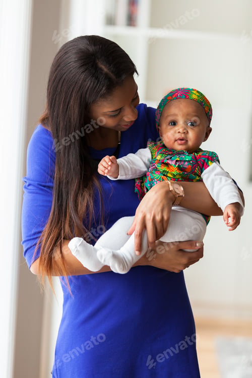Preview: Young african american mother playing with her baby girl