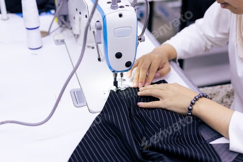 Preview: Tailor working on electric sewing machine