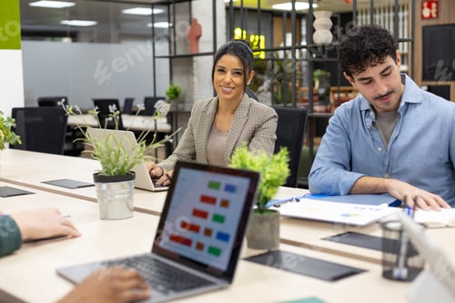 Preview: Diverse business team collaborating in modern office meeting