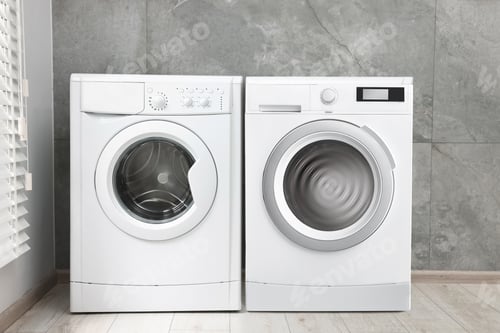 Preview: Two washing machines near tiled wall in laundry room