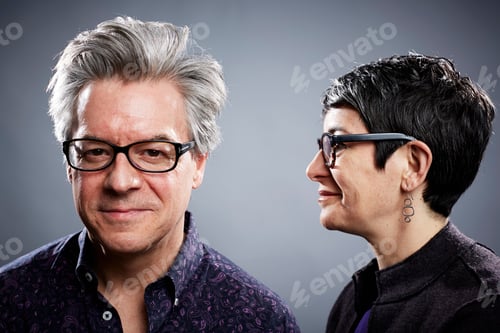 Preview: Studio portrait of mature businessman with businesswoman in profile