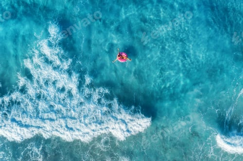 Preview: Aerial view of woman in the sea with waves