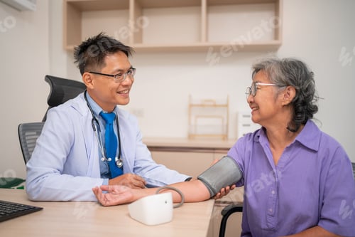 Preview: Doctor using digital pressure gauge measuring blood pressure of elderly woman patient.