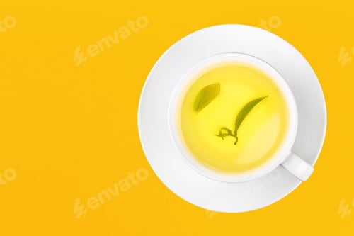 Preview: Cup of green oolong tea over yellow