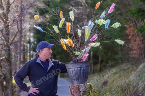Preview: Middleage senior man with easter decoration in the garden