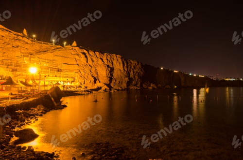 Preview: Seaside resort cliff illuminated by night lights